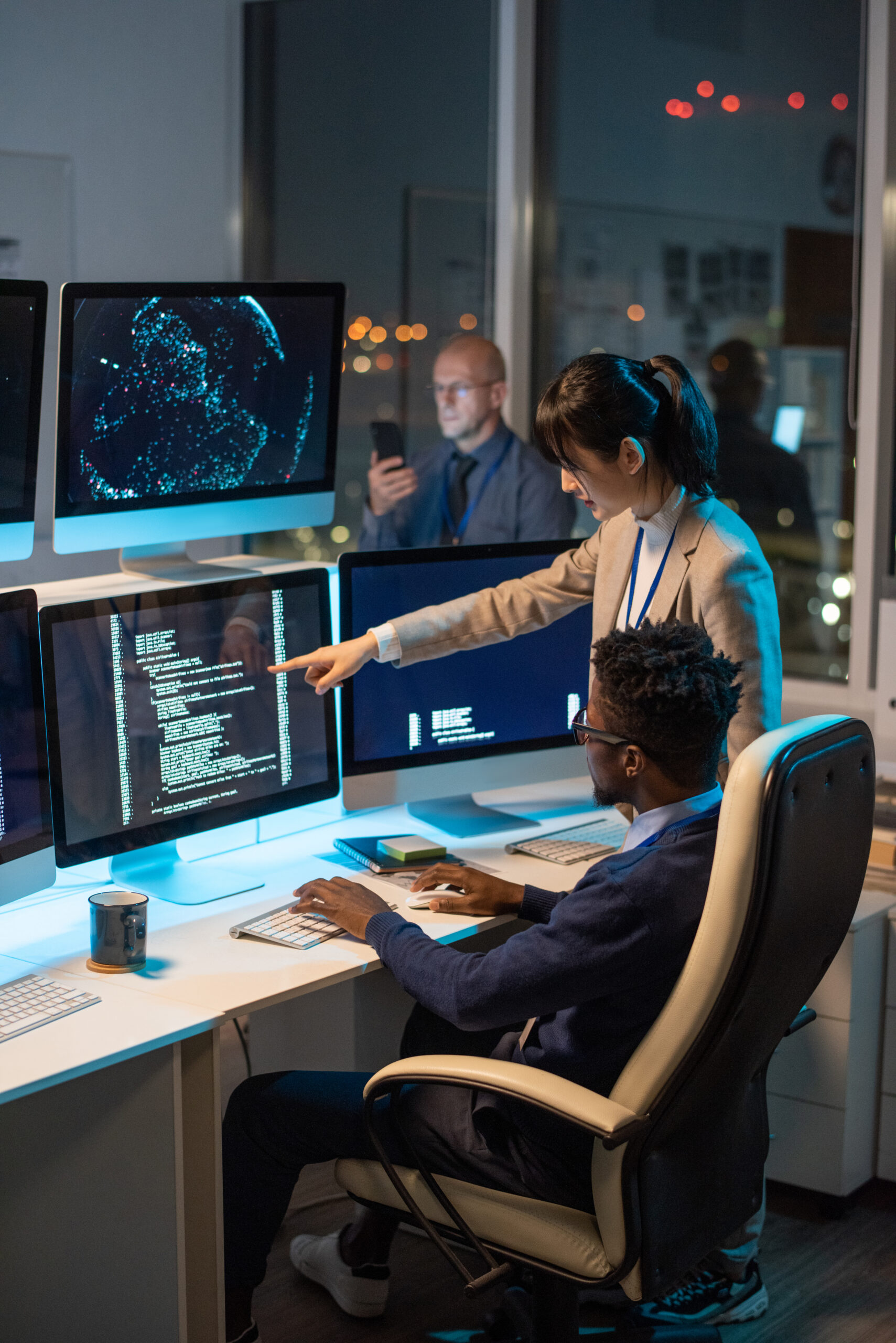 Young Asian businesswoman pointing at computer screen